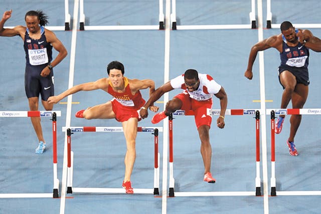 Cuba's Dayron Robles (second right) makes contact with Liu Xiang during the men's 110m hurdles final