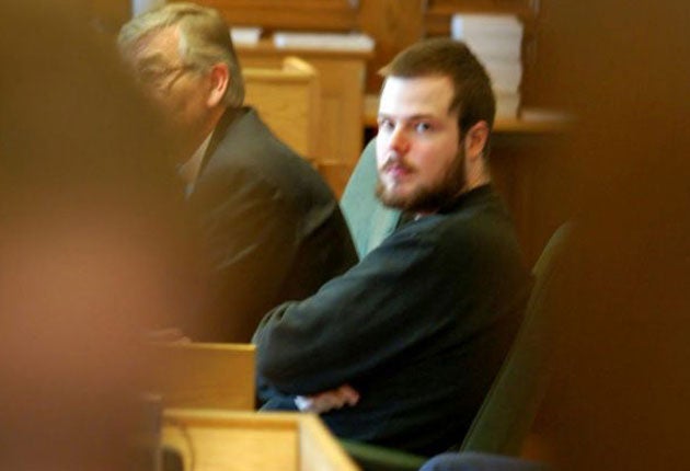 Mijailo Mijailovic sits next to his lawyer Peter Althin in a Stockholm court