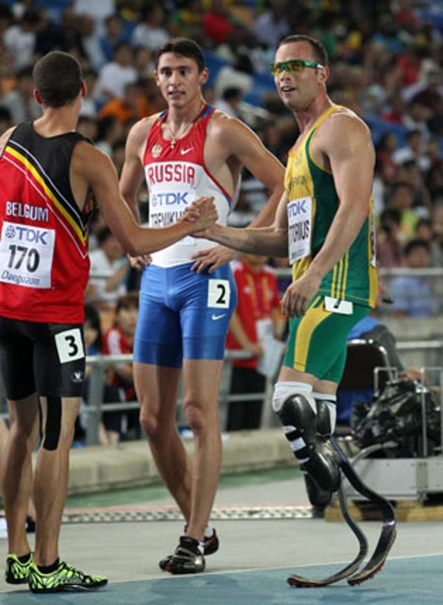 Oscar Pistorius shakes hands with Jonathan Borlee from Belgium after the race