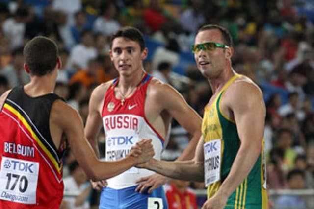 Oscar Pistorius shakes hands with Jonathan Borlee from Belgium after the race