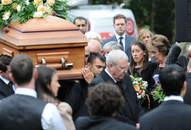 Gemma Redmond follows the coffin out of the church with her parents