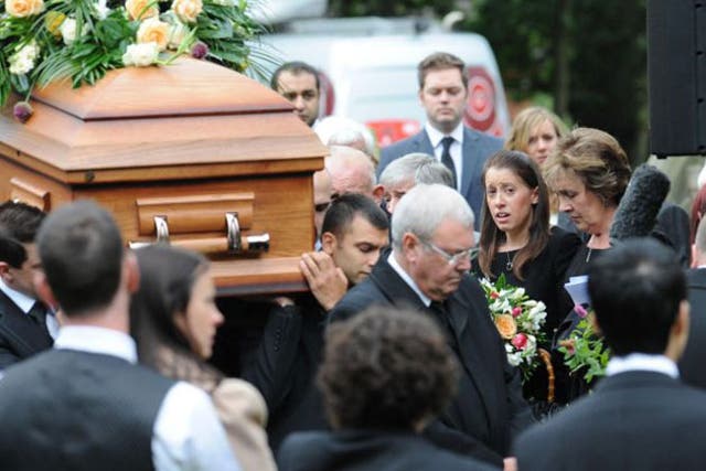 Gemma Redmond follows the coffin out of the church with her parents
