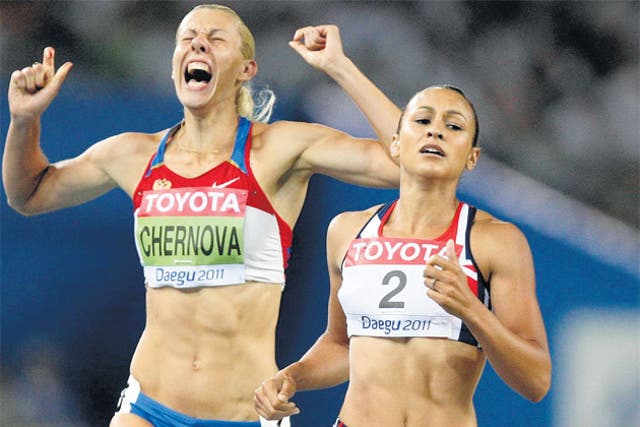 Jessica Ennis (right) fails to shake off Tatyana Chernova in the 800m allowing the Russian to win the heptathlon gold medal yesterday