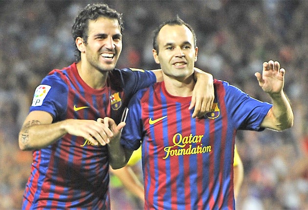 Cesc Fabregas (left) and Barcelona team-mate Andres Iniesta enjoy the victory over Villarreal