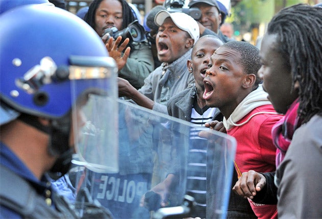 Supporters of the ANC Youth League leader Julius Malema confront police in Johannesburg during his hearing for 'sowing divisions'