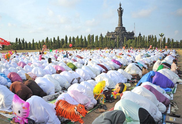 Indonesian women take part in special prayers for Eid al-Fitr at Bali's Bajra Sandhi monument in Denpasar