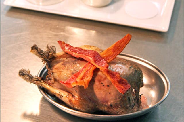 Grouse served in the traditional way, seared in duck fat and dressed with bacon
