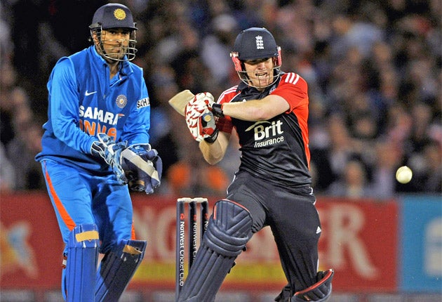 England's Eoin Morgan hits out on his way to 49 last night watched by India wicketkeeper M S Dhoni