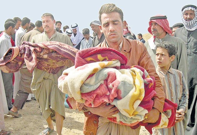 Iraqis with the bodies of children allegedly killed in the US raid on Ishaqi in March 2006