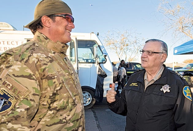 Actor Steven Seagal, in camouflage gear, with Sheriff Joe Arpaio. They are being sued for $100,000