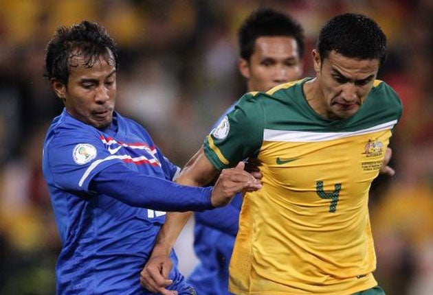 Australia's Tim Cahill (right) under pressure during the World Cup qualifying victory over Thailand