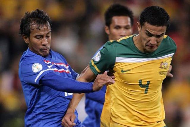 Australia's Tim Cahill (right) under pressure during the World Cup qualifying victory over Thailand