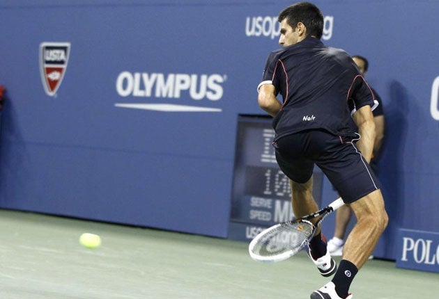 Novak Djokovic completes his three-set demolition of Carlos Berlocq with a 'hot dog' shot between his legs