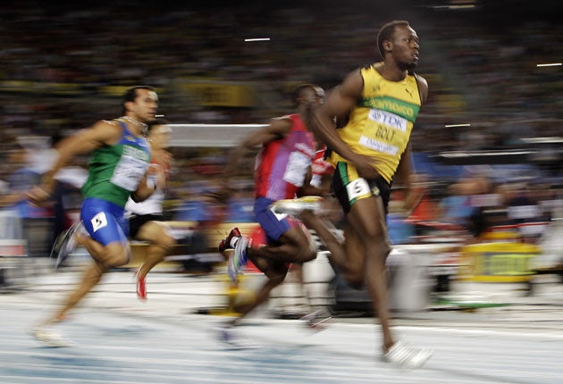 Usain Bolt (right) cruises through his 200m semi-final in 20.31sec to book a place in today's final