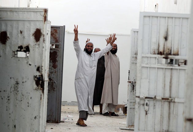 Victory signs from men freed from the notorious prison in Abu Salim after the district was seized by rebels