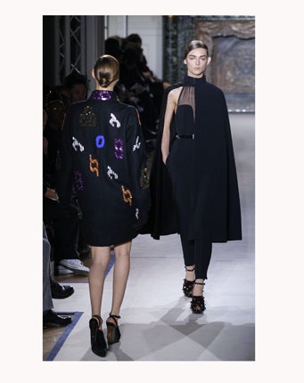Yves Saint Laurent's Stefano Pilati proposes a black silk cape should be buttoned at the throat over a Le Smoking all-in-one finished with chiffon