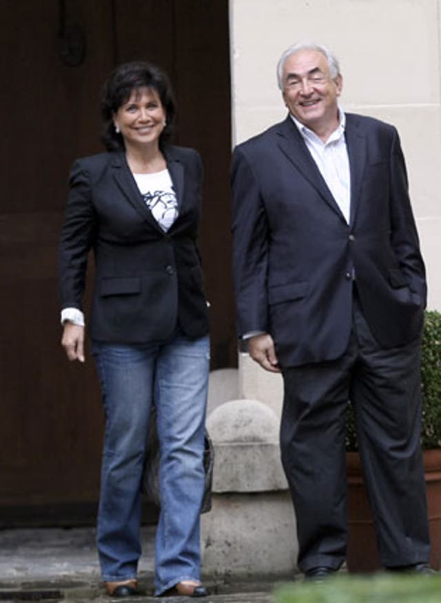 Dominique Strauss-Kahn and his wife, Anne Sinclair, in the courtyard of their Paris home yesterday