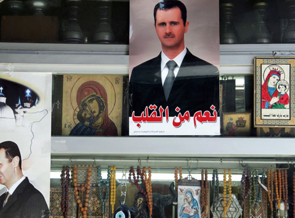 Portraits of President Bashar al-Assad at a shop selling Christian icons in Damascus