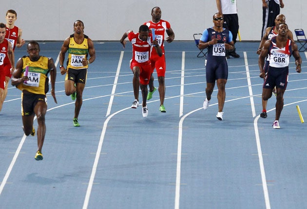 Usain Bolt races away to set a new 4x100m relay world record for Jamaica as the US and Great Britain (right) fail to finish