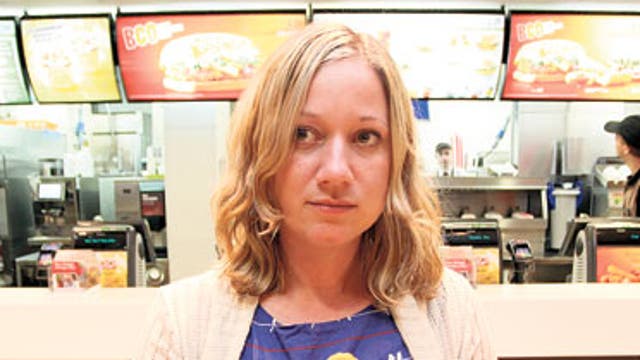 Genevieve Roberts sampling some fast food in a McDonald's