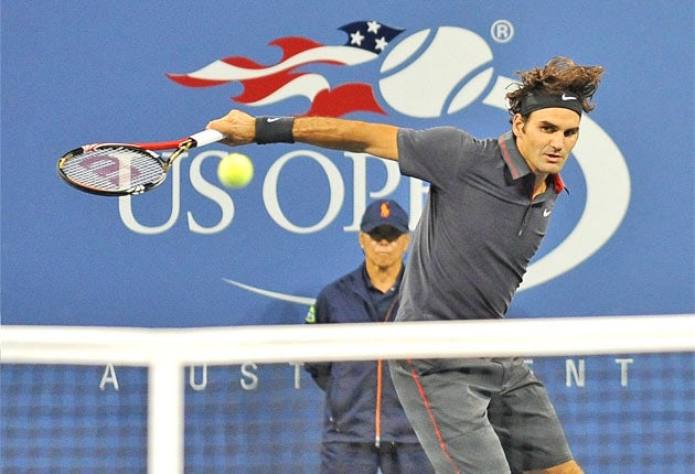 Roger Federer hits a return to Juan Monaco, of Argentina, during his fourth-round romp