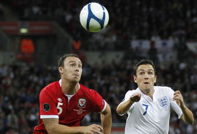 Stewart Downing (right) takes on Wales' Darcy Blake
