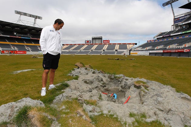 England coach Martin Johnson inspects earthquake damage on the field during a England IRB Rugby World Cup 2011 squad visit to AMI Stadium