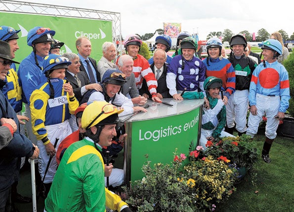 Famous former jockeys including Julie Krone (left, yellow and blue silks) and Lester Piggott (centre, rear) ahead of the Leger Legends race yesterday