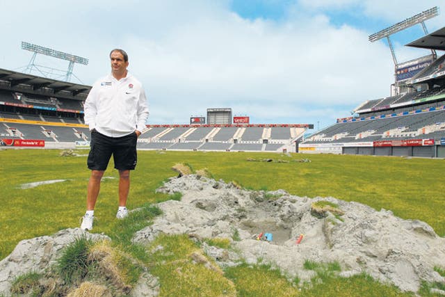 Martin Johnson inspects the damage caused to the AMI Stadium pitch by the Christchurch earthquake