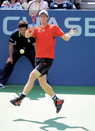Andy Murray hits a return during yesterday's victory over Donald Young