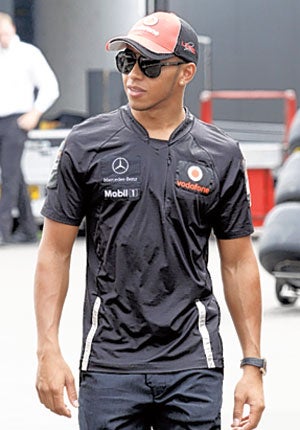 Lewis Hamilton arrives in the paddock at the Monza circuit yesterday