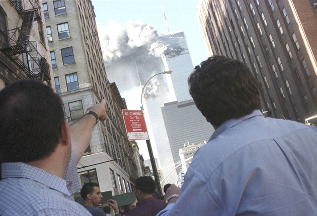 Pedestrians react to the attacks on the World Trade Center in New York on September 11, 2001