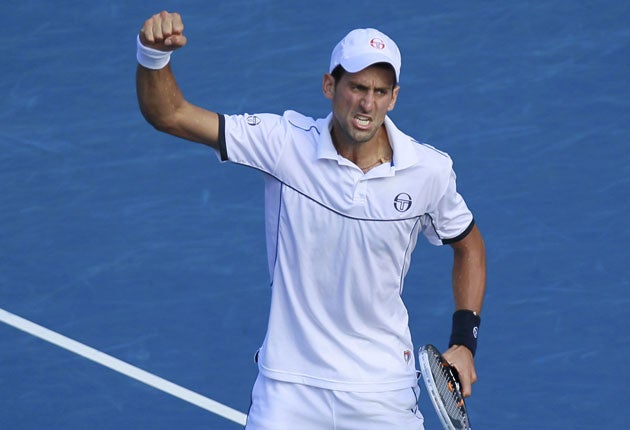 Novak Djokovic celebrates his five-set victory over Roger Federer after
facing two match points against the Swiss for the second succeesive year