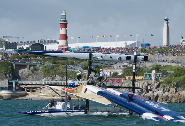 Over she goes. The Aleph team from France flips its wing-powered
trimaran in front of the watching audience on Plymouth Hoe