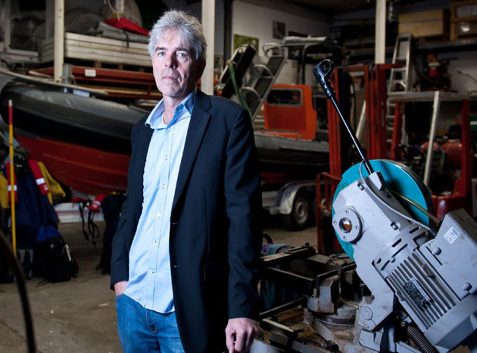 Greenpeace director John Sauven stands before one of the organisation's boats at its operations centre in Islington, London