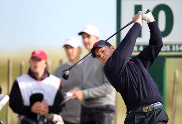Michael Stewart, of Great Britain and Ireland, tees off during the morning foursomes yesterday