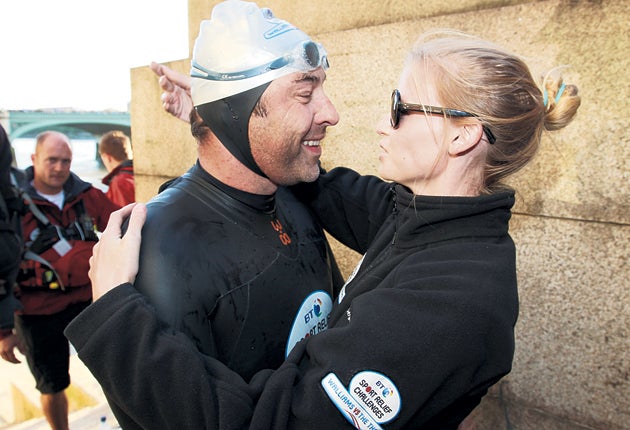 David Walliams greets his wife, Lara Stone, after swimming the length of the Thames for Sport Relief