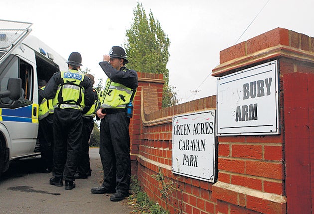 Officers at the Green Acres site, where four residents were arrested on suspicion of slavery offences