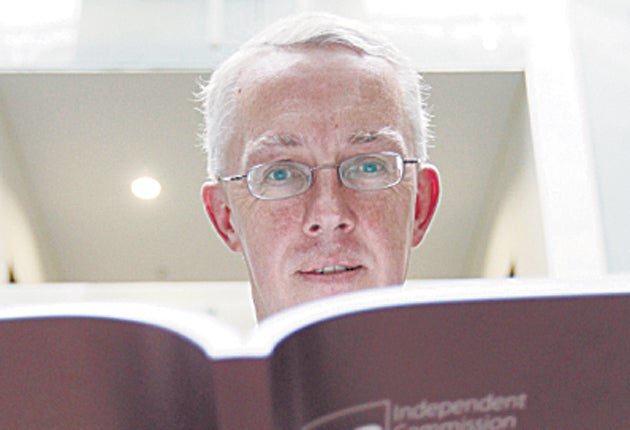John Vickers, the head of the Independent Commission on Banking with a copy of his report