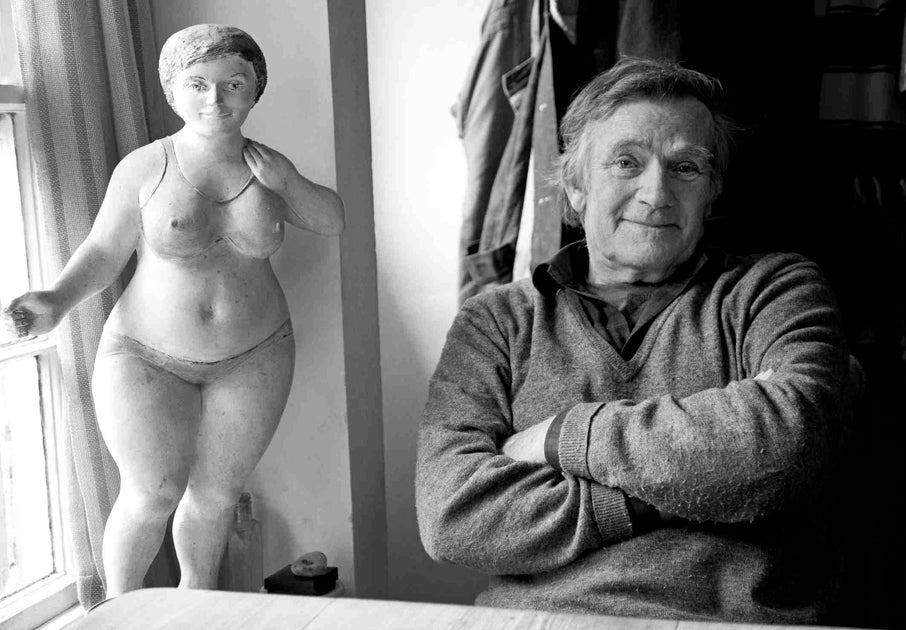 Portrait of Ray Exworth beside one of his sculptures