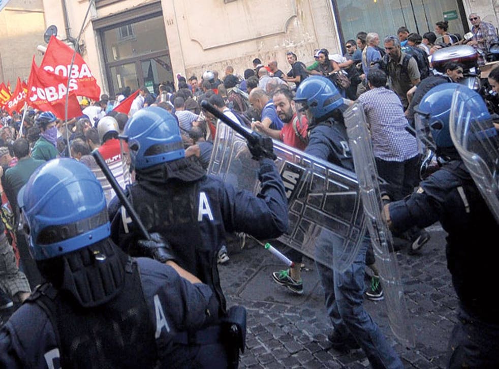 Policemen clashing with protesters near the Italian parliament