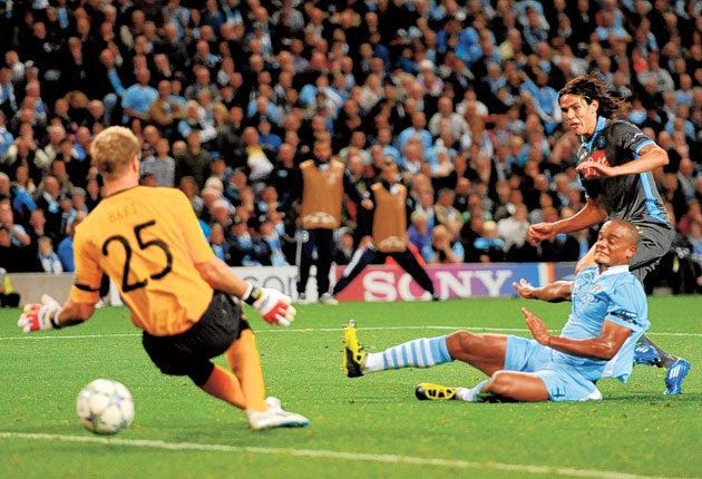 Edinson Cavani slides the ball under Joe Hart to open the scoring for
Napoli in Manchester last night