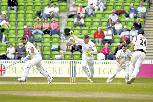 Lancashire all-rounder Tom Smith wheels away in delight after catching Alfonso Thomas