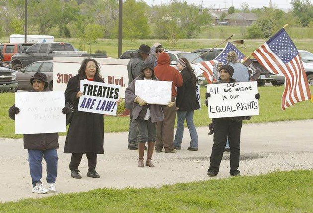 Descendants of slaves once owned by the Cherokee demonstrate against the ban