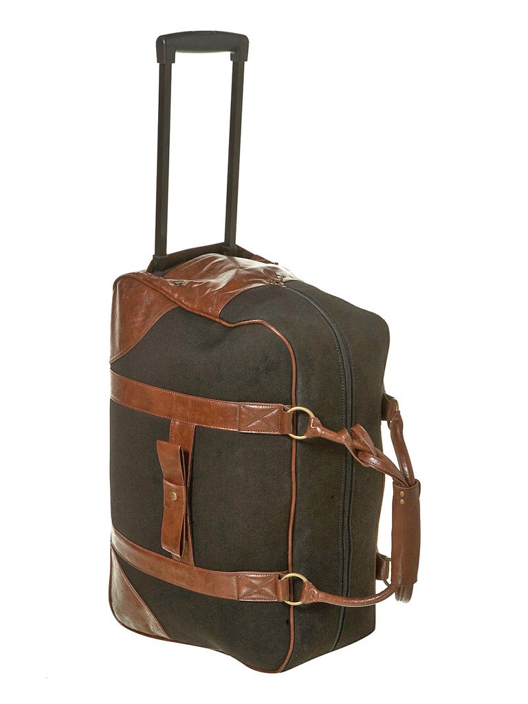 <b>BLACK CANVAS TROLLEY:</b> Topman comes up trumps with its chocolate brown and black Luggage bag. The traditional design comes complete with an extendable handle and wheels so you don't have to worry about packing anything too heavy to heft. £85, topshop.com