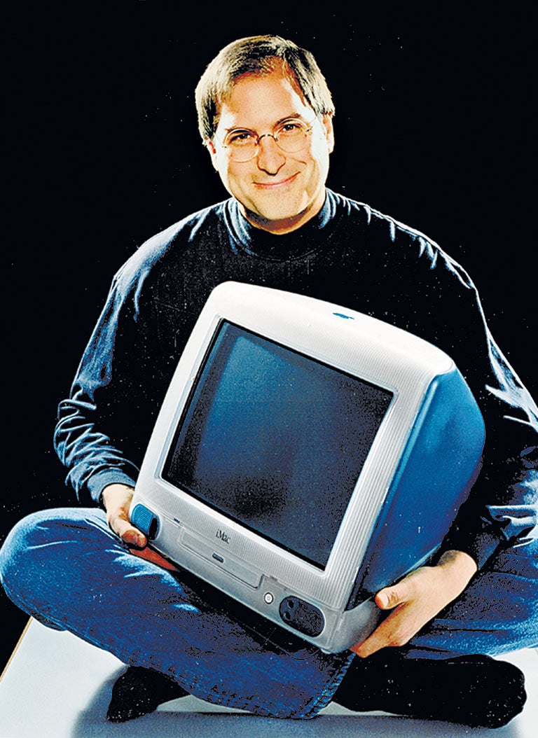 Steve Jobs holding an iMac in 1998