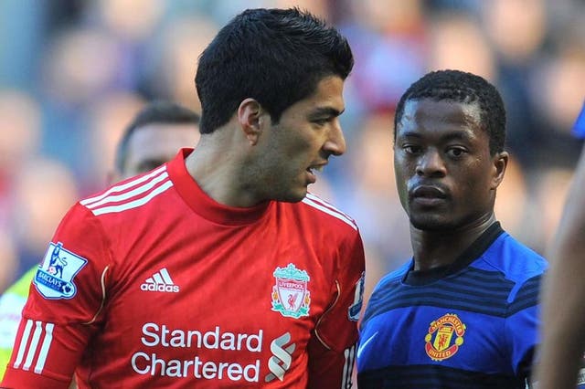 Suarez, left, was banned following the incident with Patrice Evra