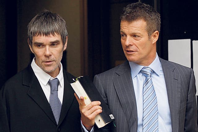 Ian Brown, lead singer of the Stone Roses, leaves court yesterday with his solicitor 'Mr Loophole' Nick Freeman