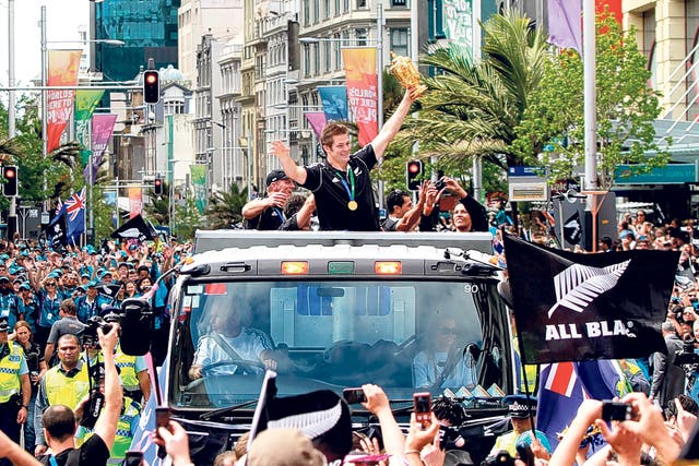 The All Blacks' Richie McCaw parades the Webb Ellis Trophy in Auckland yesterday 