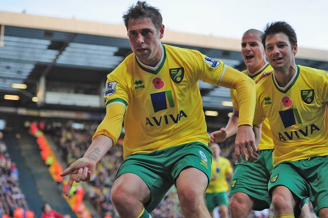 Norwich's Grant Holt runs to the fans to celebrate after his late penalty earned his side a point and continued their fine start to the season